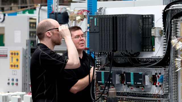 Two engineers looking at servers.
