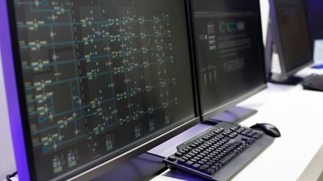Two monitors with SCADA systems on them.