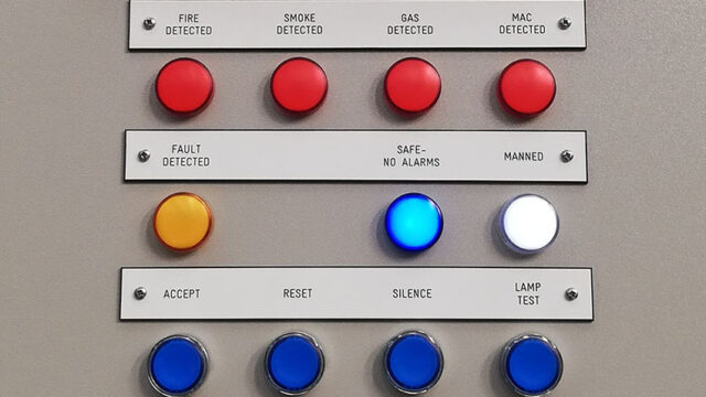 A photograph of a control panel with different coloured buttons.