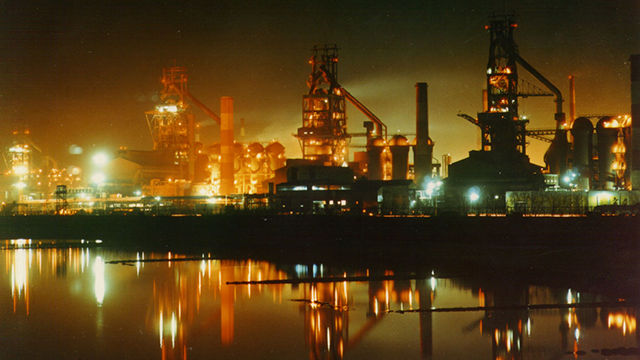 A photograph of iron and steel works buildings at night in South Korea.