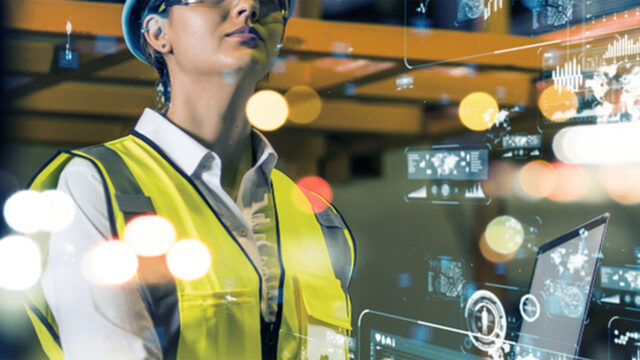 A woman in a high-vis looking at statistics.